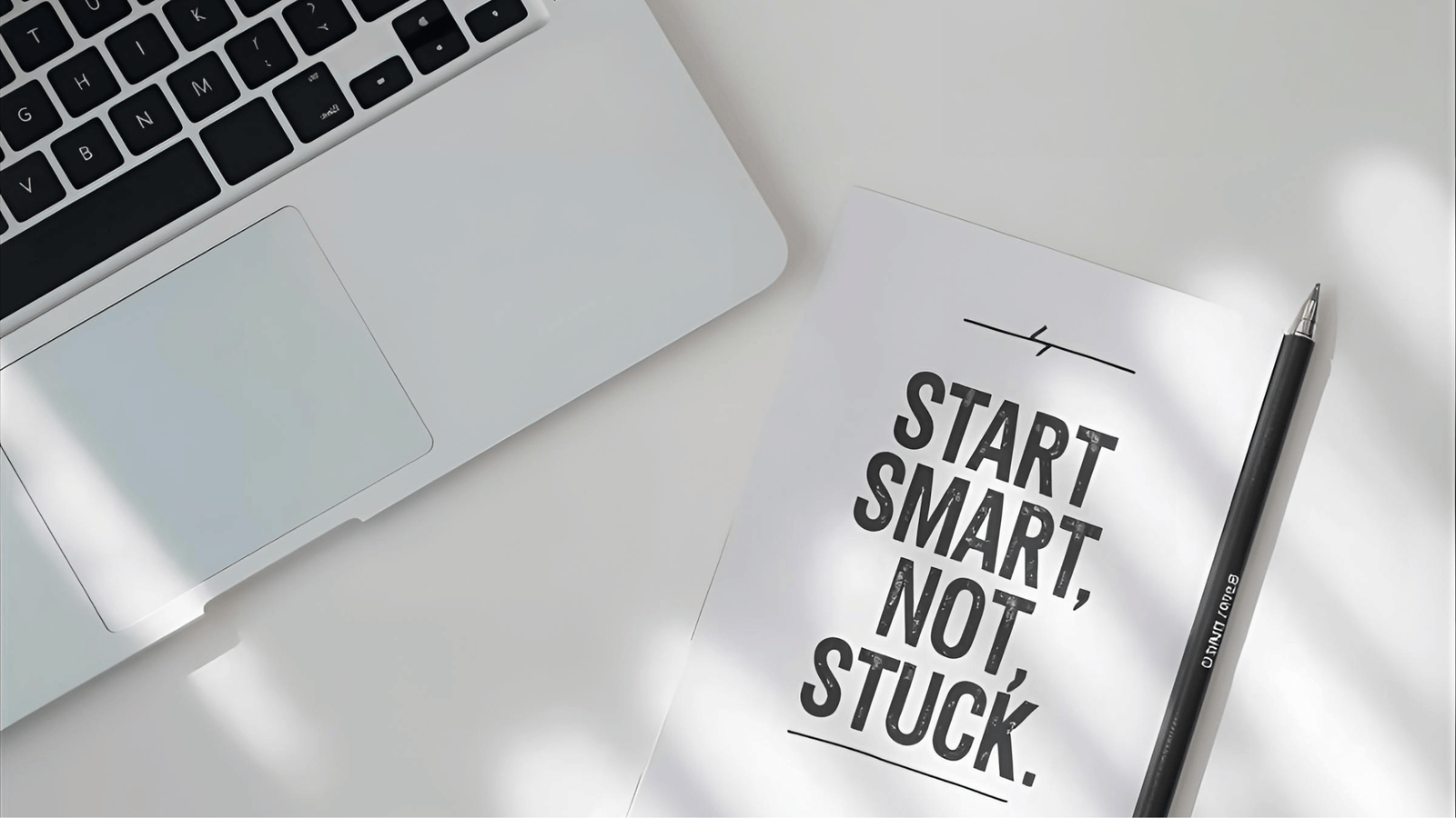 a notebook with a pen and a pen on a desk