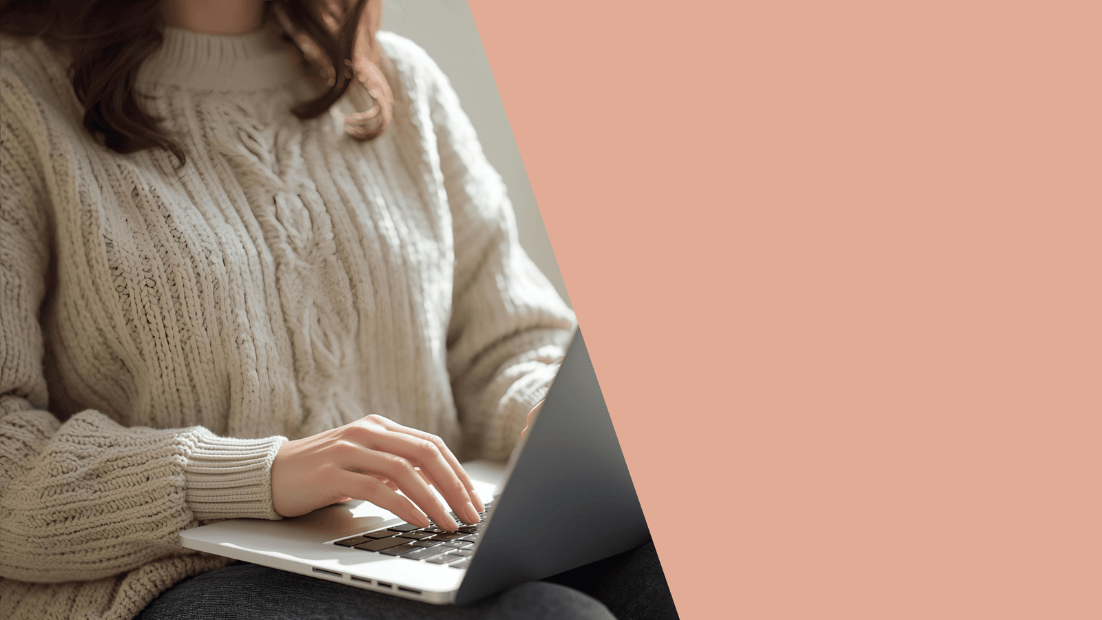 a woman sitting on a couch using a laptop